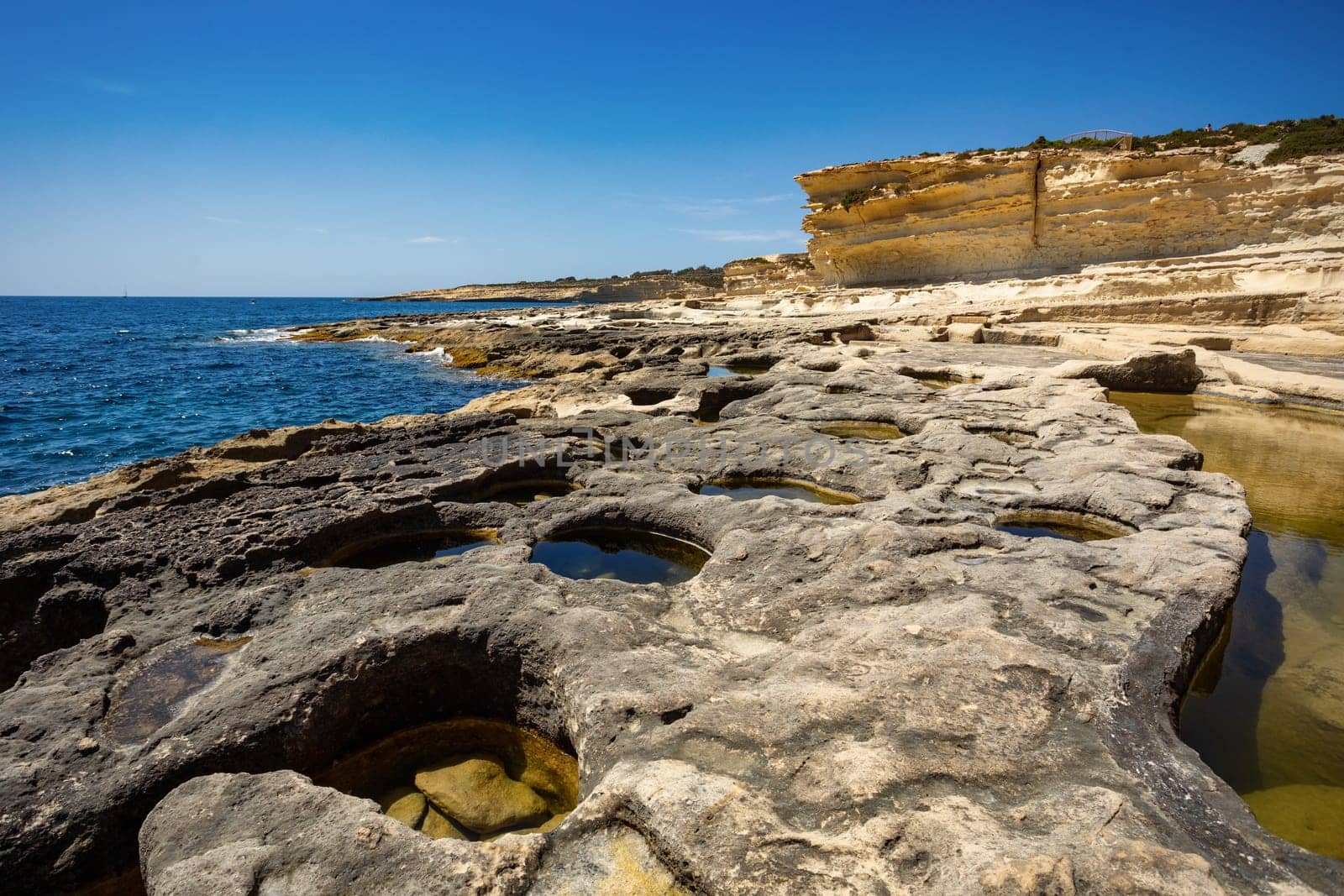 Beautiful coastal view of Delimara peninsula, with rocks and turquoise sea, near Saint Peter's Pool, Island Malta natural landscape.