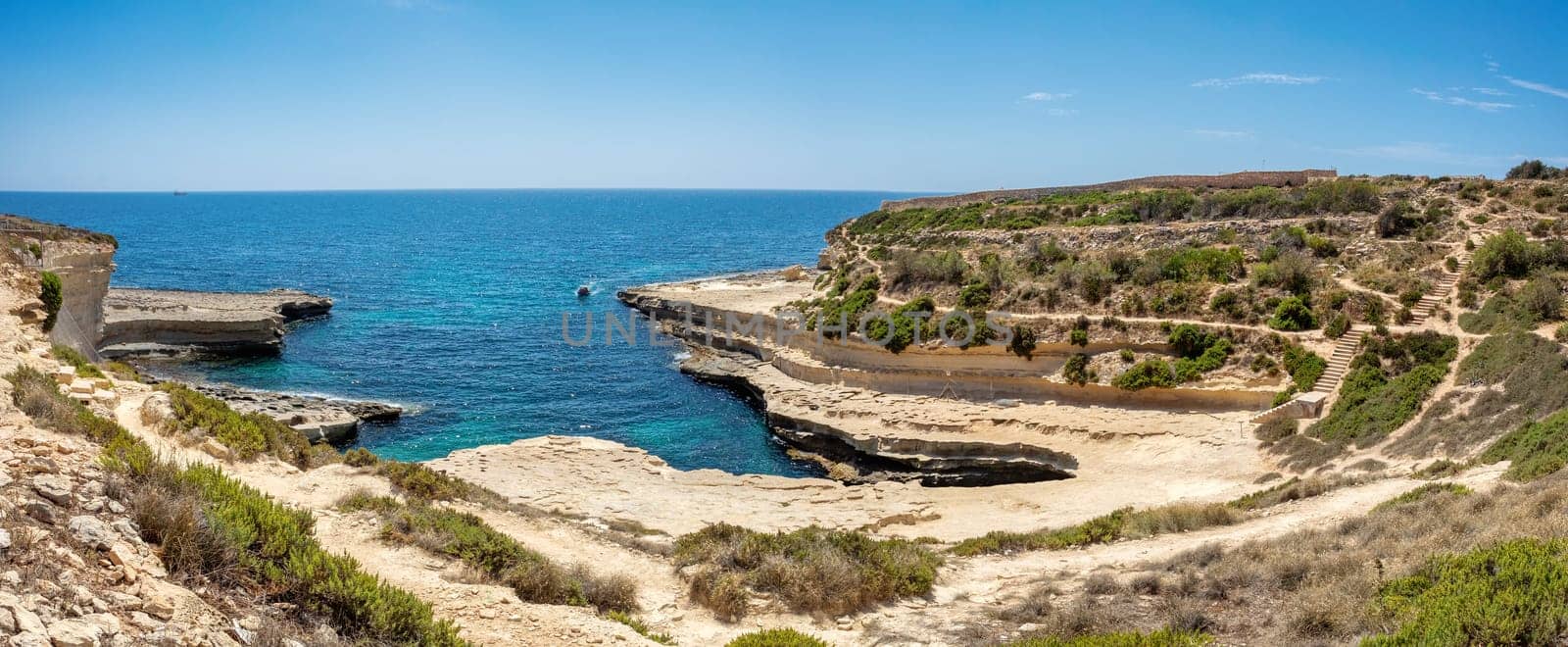 Saint Peter's Pool, beautiful coastal view of Delimara peninsula, with rocks and turquoise sea, Island Malta natural landscape.