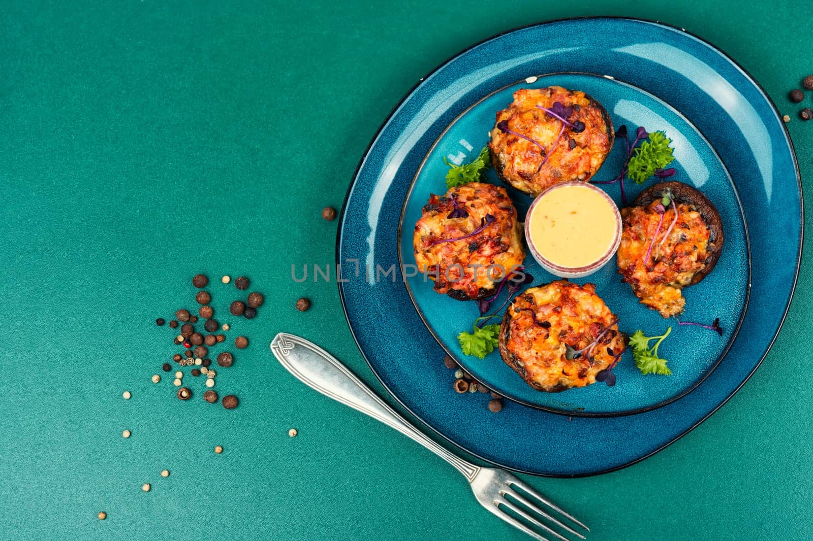 Stuffed mushrooms, champignon mushroom caps filled with vegetables on rustic wooden table. Healthy food