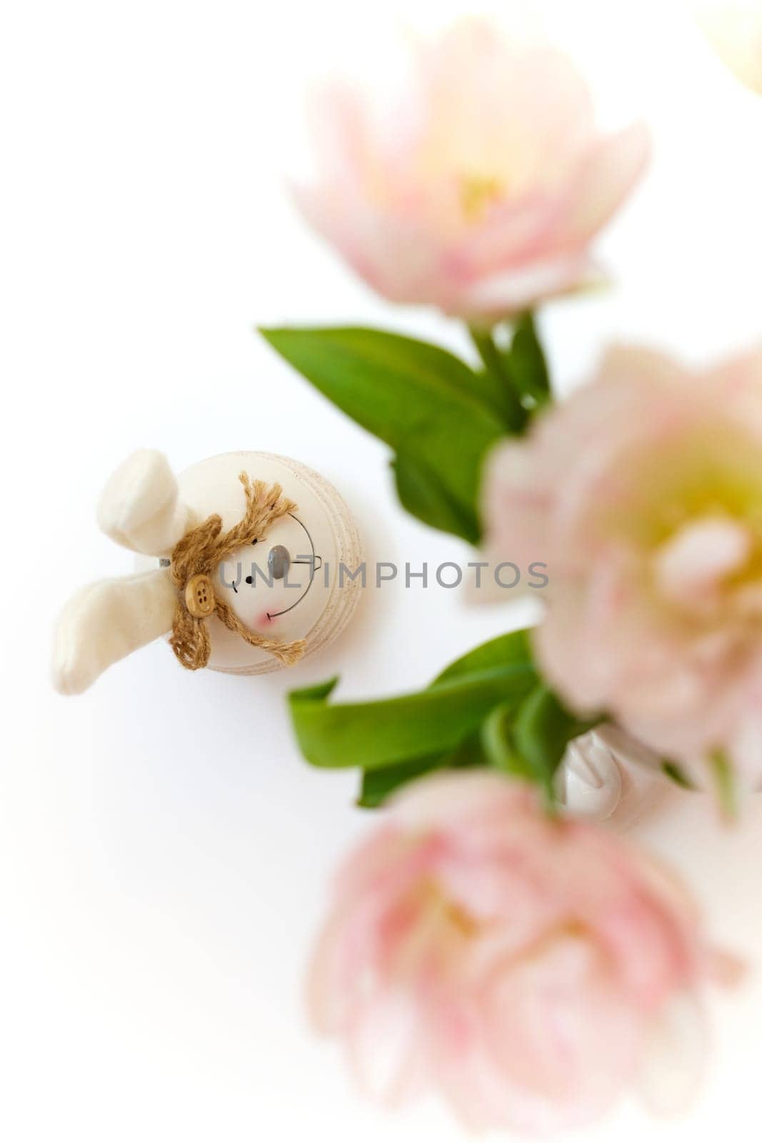 bouquet of tulips and Easter bunny on white table. copy space