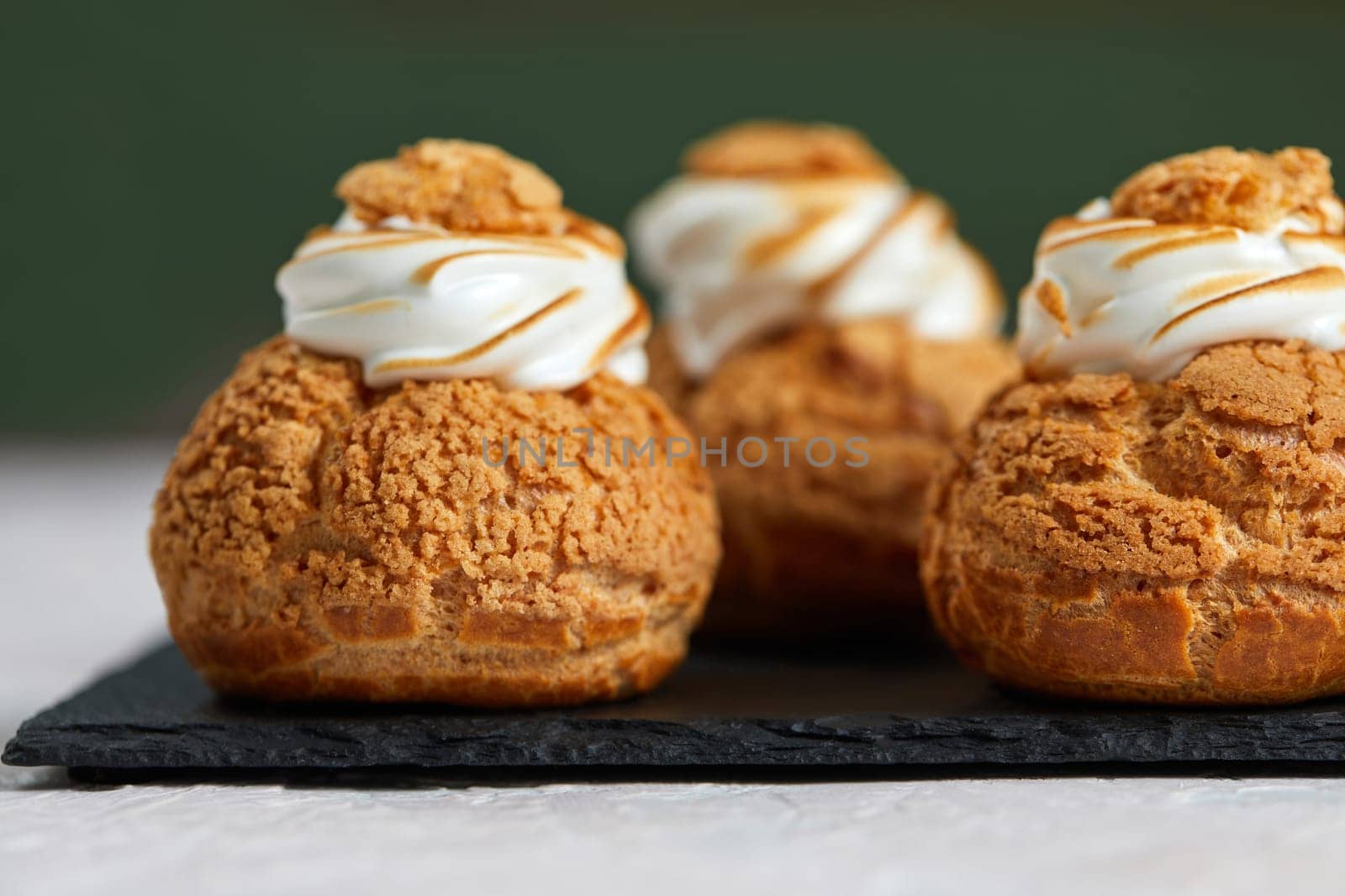 Tasty sweet cupcakes on the black tray