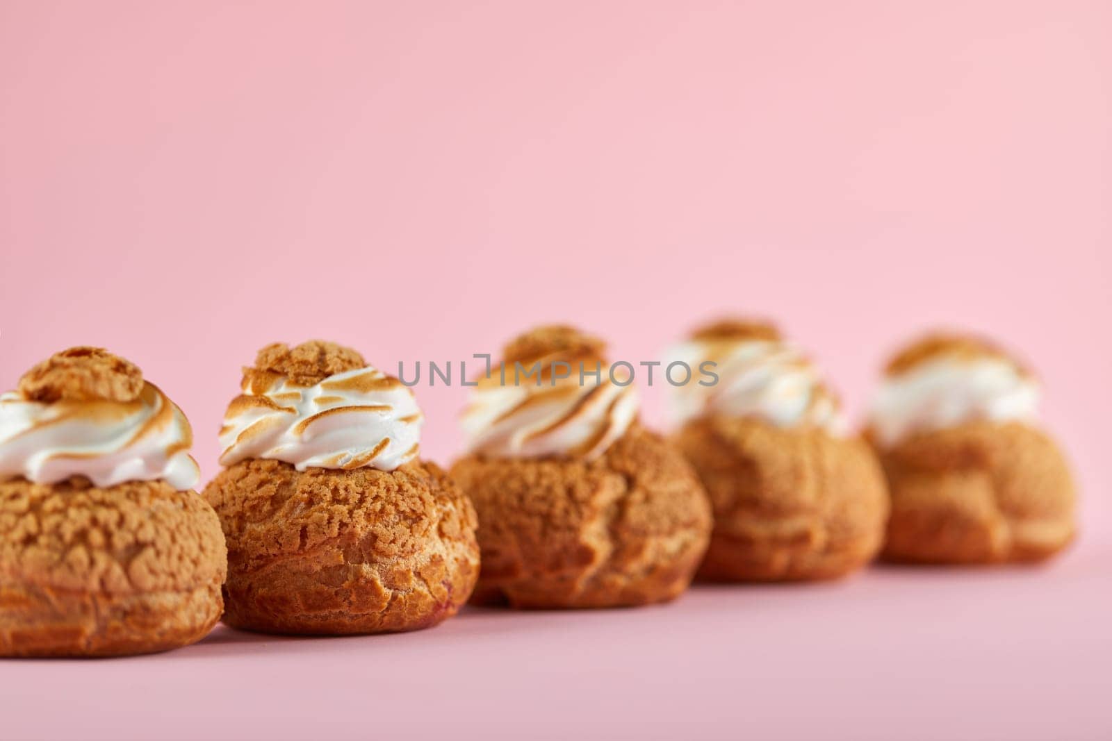 Tasty sweet cupcakes on the pink background