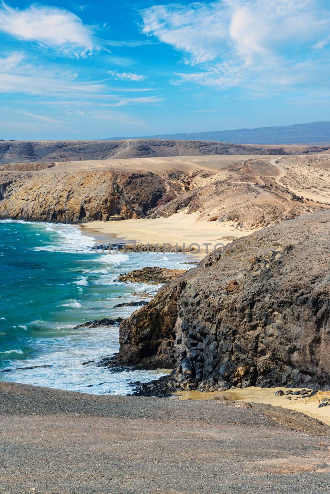 View of the Atlantic Ocean with its rocky cliffs and the beautiful Papagayo beaches on the Canary Island of Lanzarote in the Atlantic Ocean