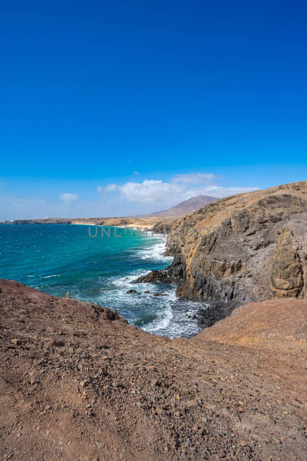 View of the Atlantic Ocean with its rocky cliffs and the beautiful Papagayo beaches on the Canary Island of Lanzarote in the Atlantic Ocean