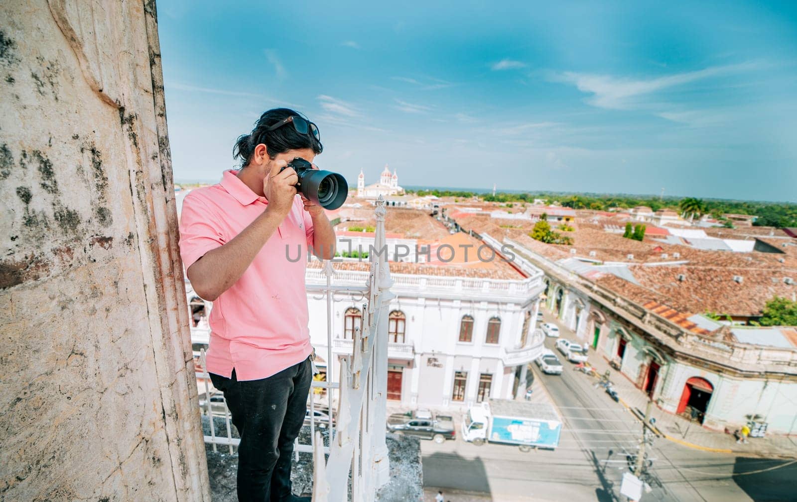 Tourist photographing the streets of Granada from the La Merced viewpoint. Tourist man taking photos of the roof of the colonial houses in Granada