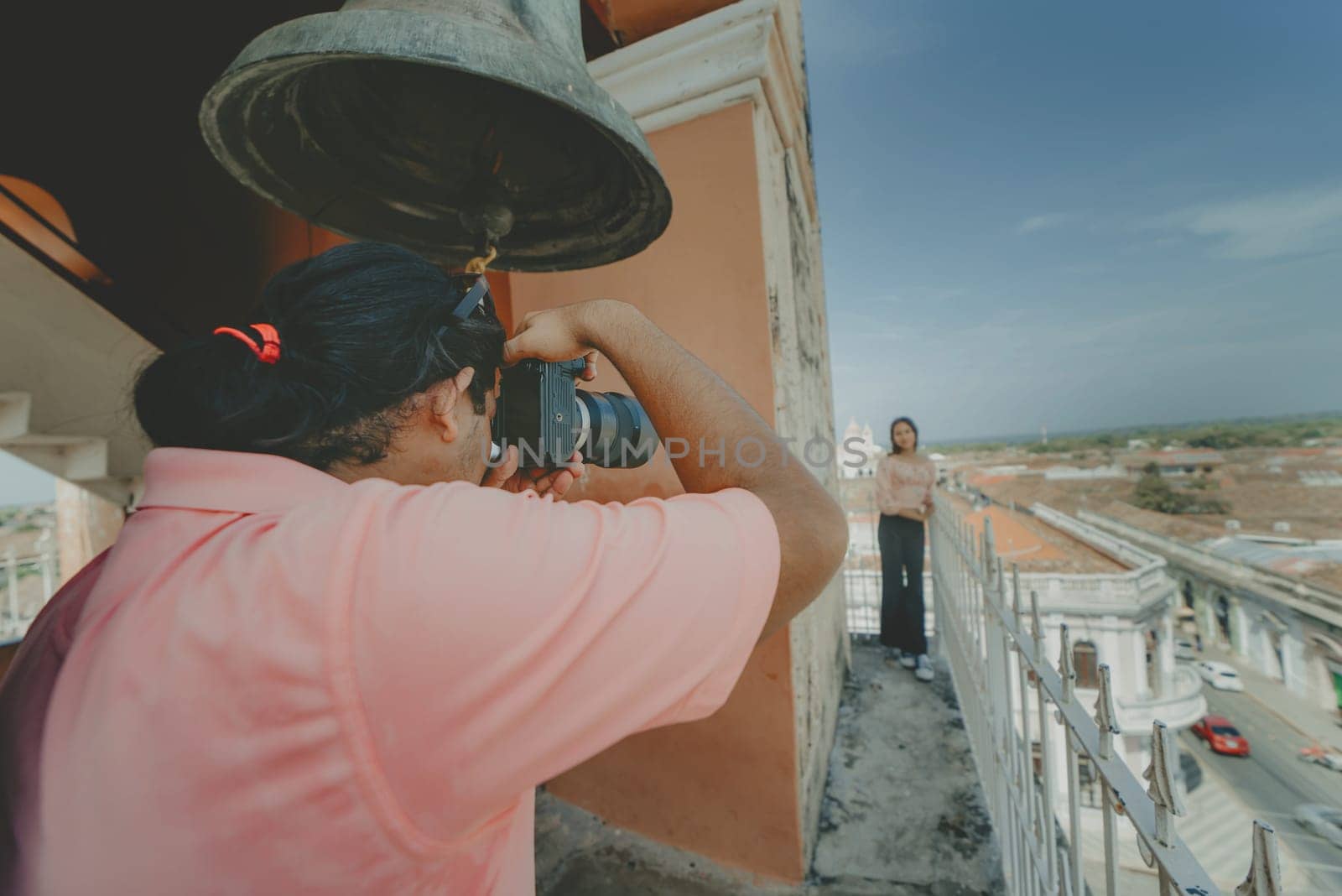 Tourists taking photographs at the viewpoint of the La Merced church, Granada. Tourist couple taking pictures at the viewpoint of the La Merced church