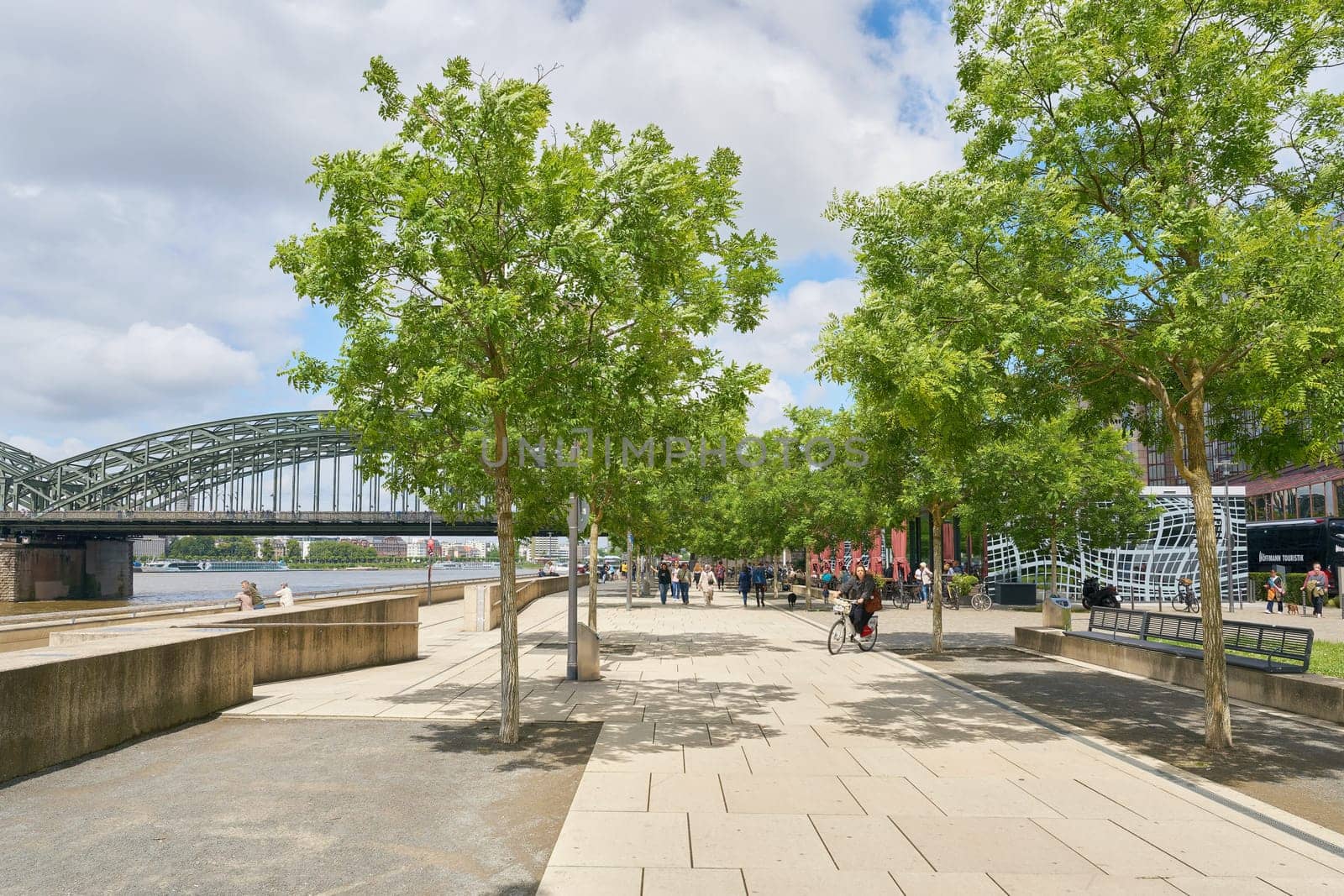 Kennedy bank, Kennedy-Ufer in Cologne on the Rhine with walkers on a beautiful day in May