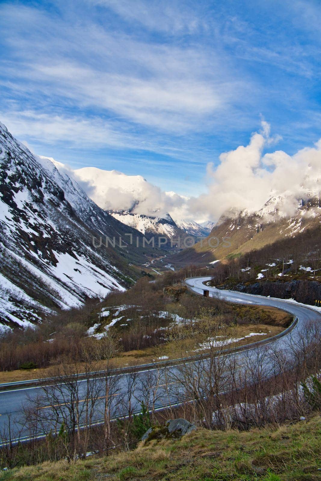 Norwegian landscape. The road leads through a mountain gorge that descends from the glacier. Rough nature in Scandinavia. Landscape photo from the north