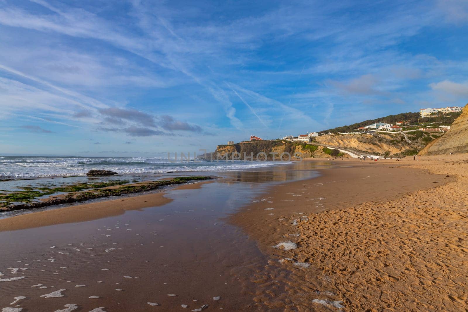 Sintra, Portugal: February 17, 2024: People at the beach of Magoito in a winter day, Sintra, Portugal