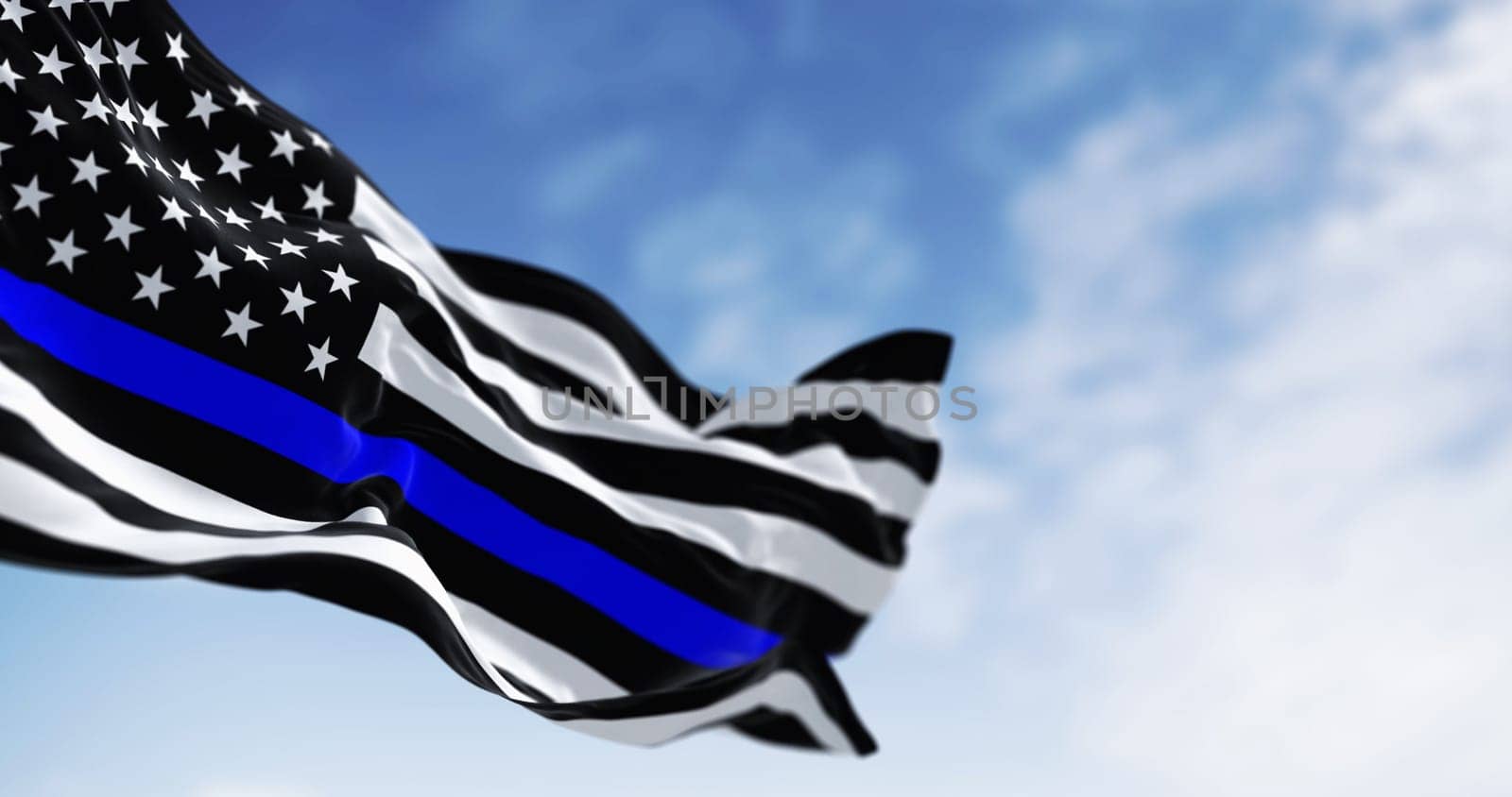 Thin blue line american flag waving in the wind on a clear day by rarrarorro