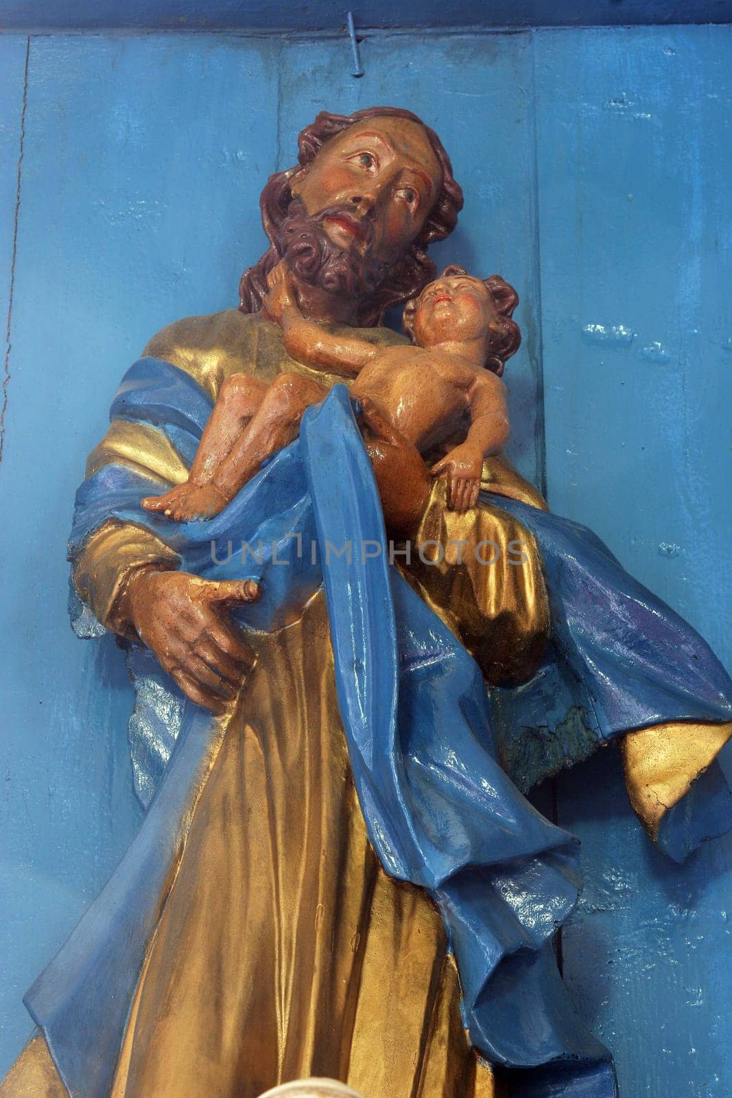 Saint Joseph holding the baby Jesus, statue on the Altar of Saint Joseph in the Parish Church of the Assumption of the Virgin Mary in Gornja Rijeka, Croatia