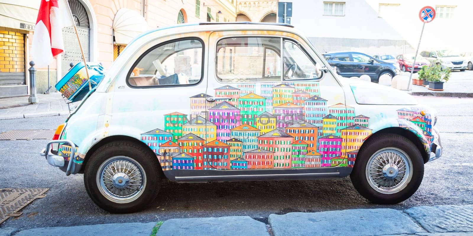 Genova, Italy - 6 August 2023: vintage Fiat 500 car painted with traditional cityscape of Liguria Region - Italy travel destination