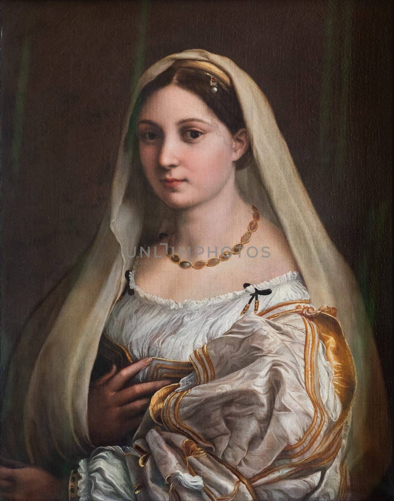 Florence, Italy - 23 September 2023: Pitti Palace antique painting museum. The vailed woman - La velata - by Raphael - Raffaello Sanzio, 1514.