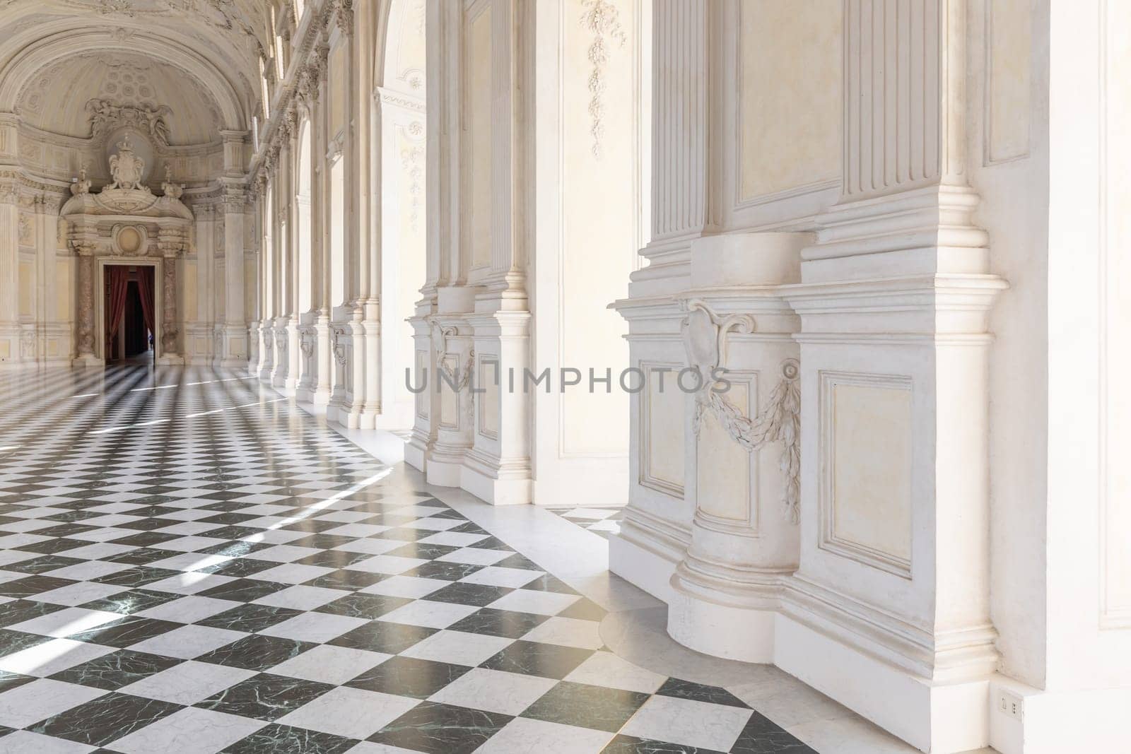Reggia di Venaria Reale, Italy - October 2022: corridor perspective, luxury marble, gallery and windows - Royal palace