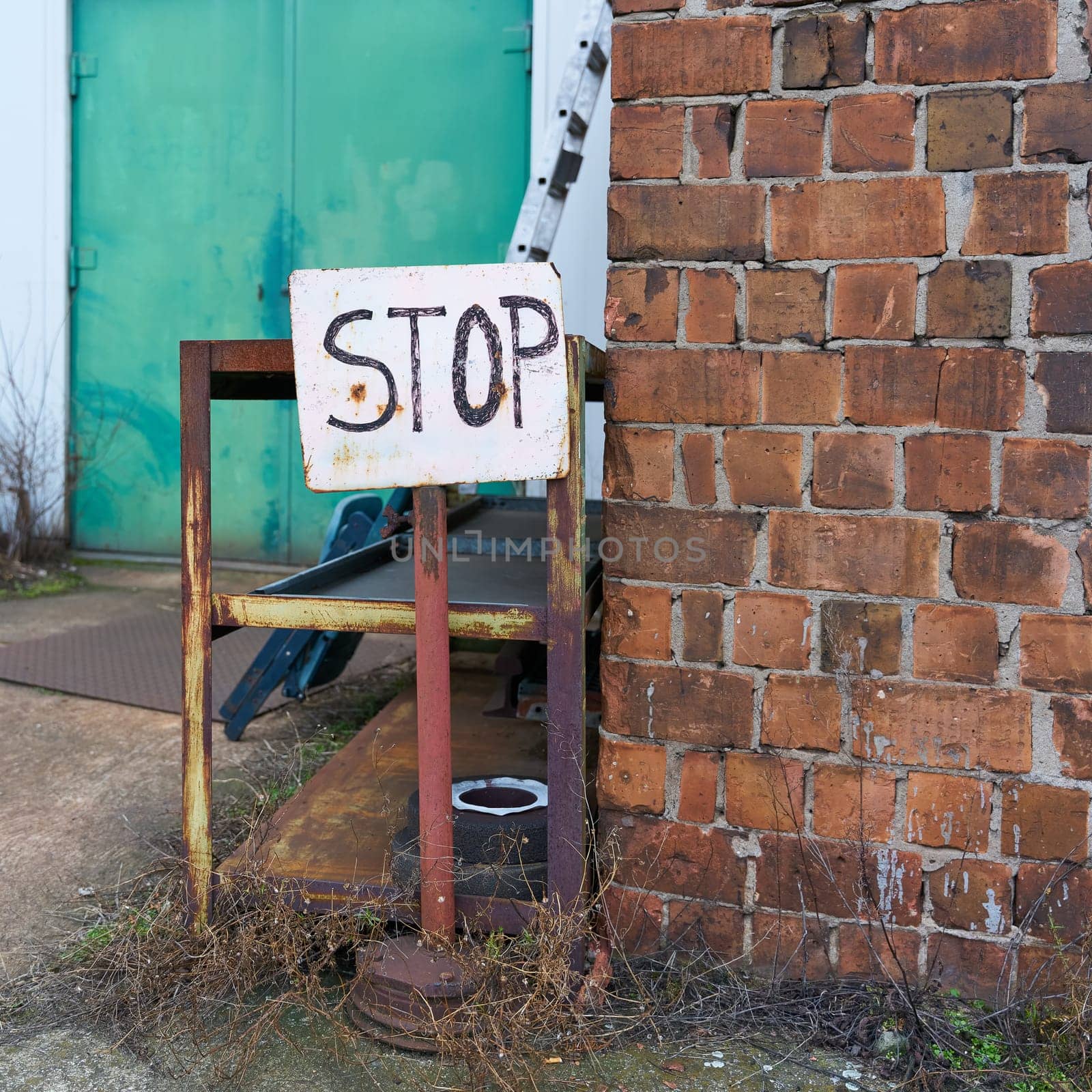 Sign with the inscription Stop on an abandoned company site on the outskirts of Magdeburg in Germany