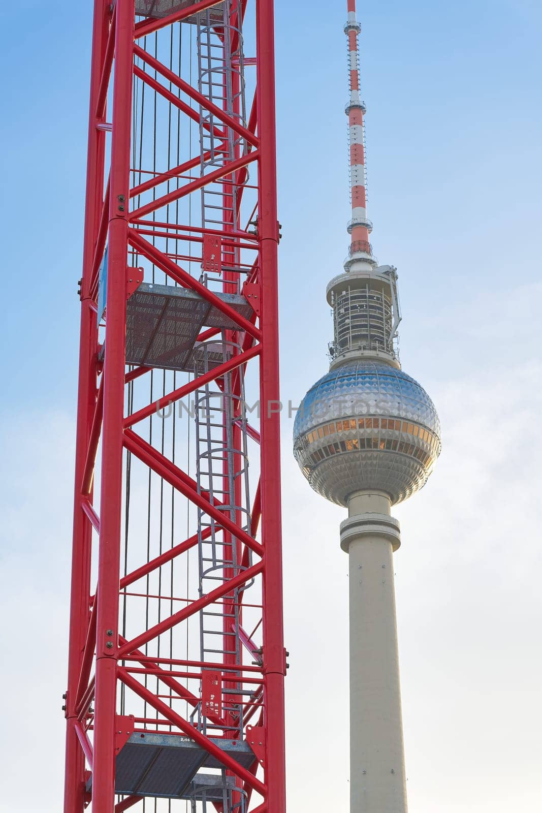 Construction crane at a building site in Berlin with the television tower in the background