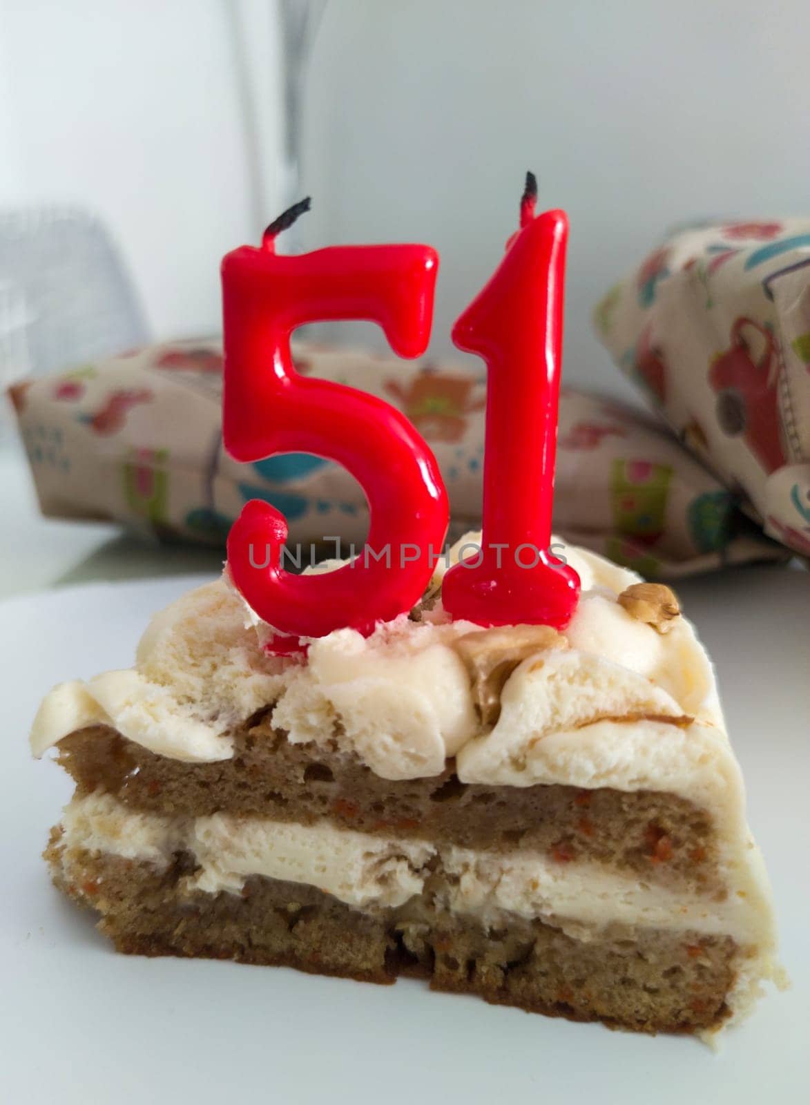 Cake with numeral birthday unlit candles. 51 years