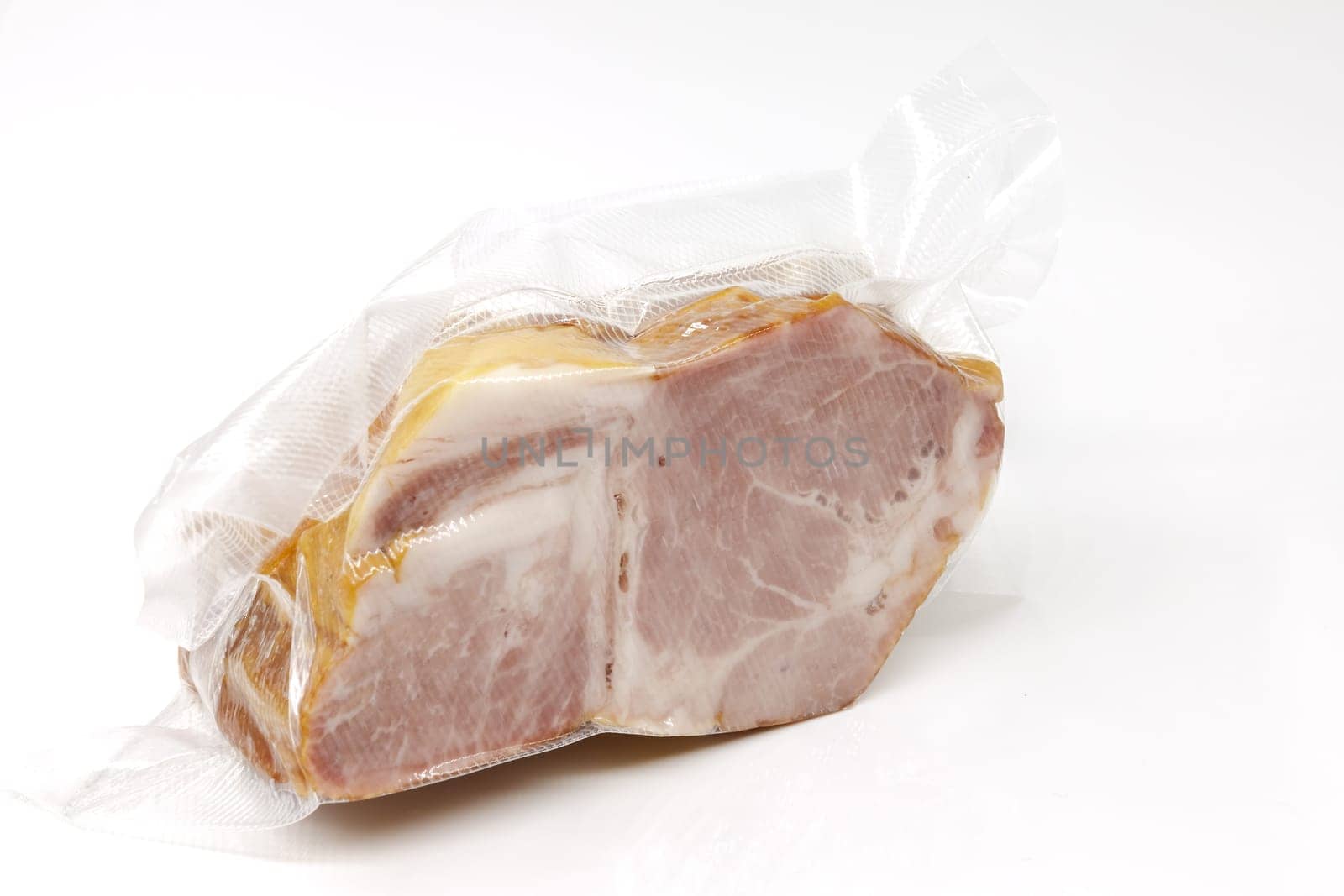 Smoked pork in vacuum packaging. Selective focus with shallow depth of field.