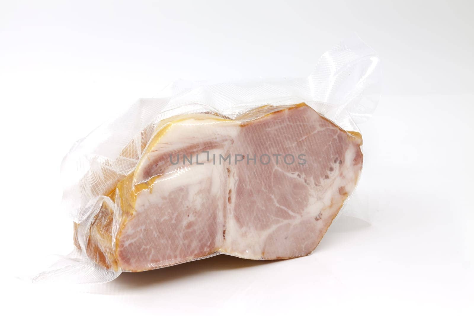 Smoked pork in vacuum packaging. Selective focus with shallow depth of field.