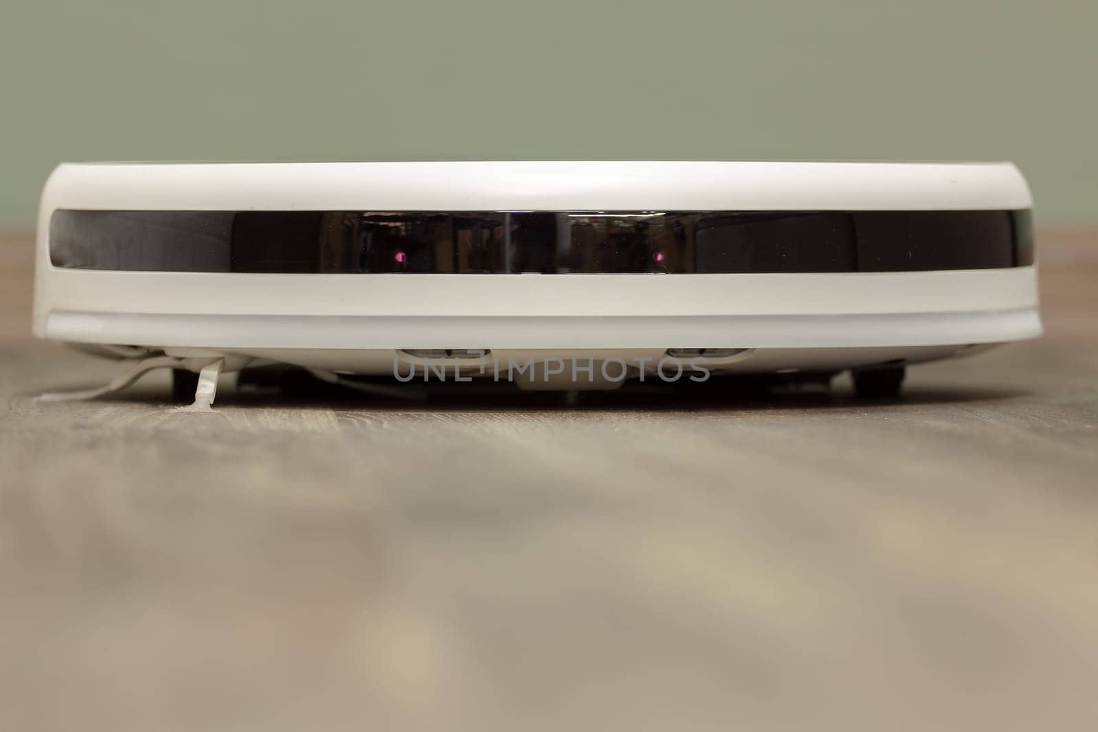 Modern digital home robot vacuum cleaner. Selective focus with shallow depth of field.