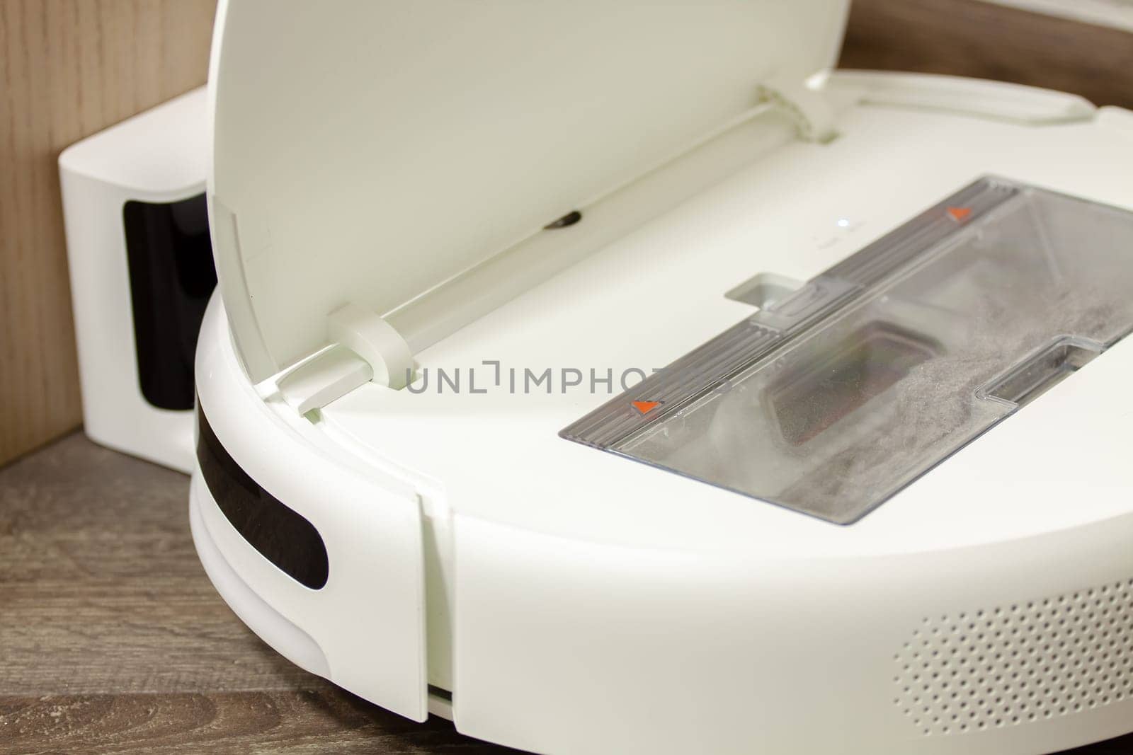 Modern digital home robot vacuum cleaner. Selective focus with shallow depth of field.