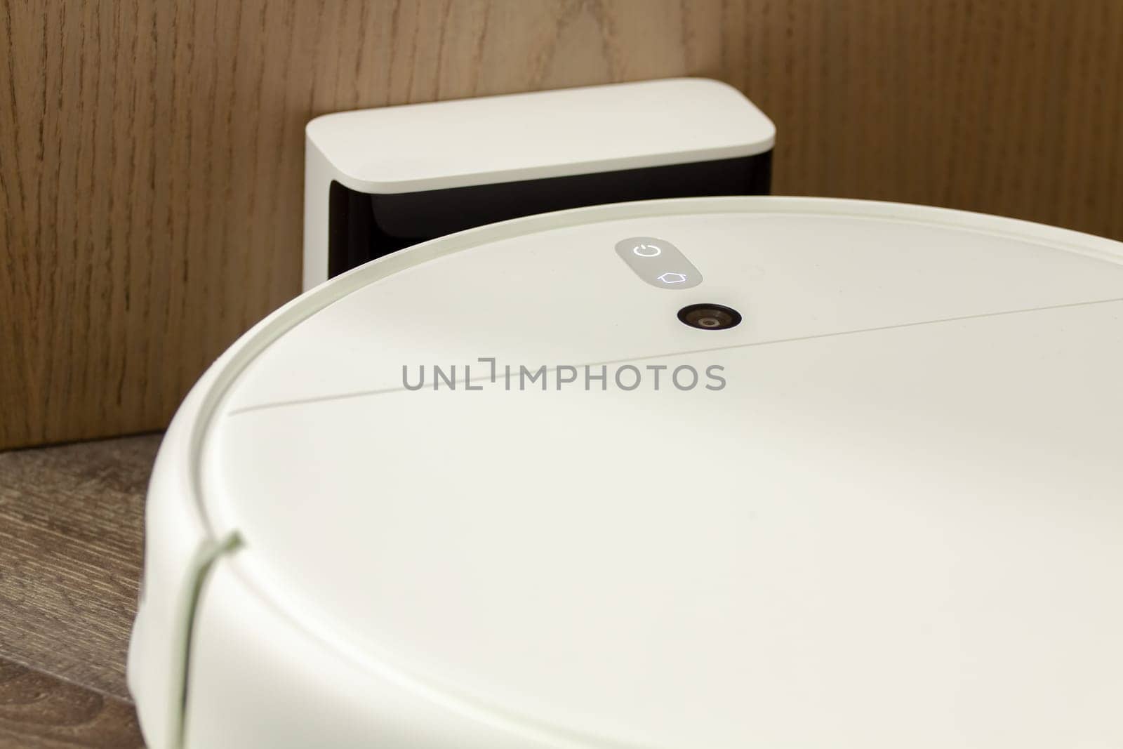 Modern digital home robot vacuum cleaner. Selective focus with shallow depth of field.
