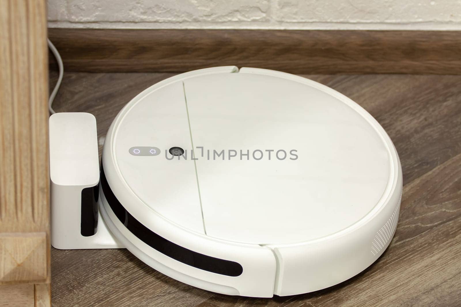 Modern digital home robot vacuum cleaner. Selective focus with shallow depth of field.