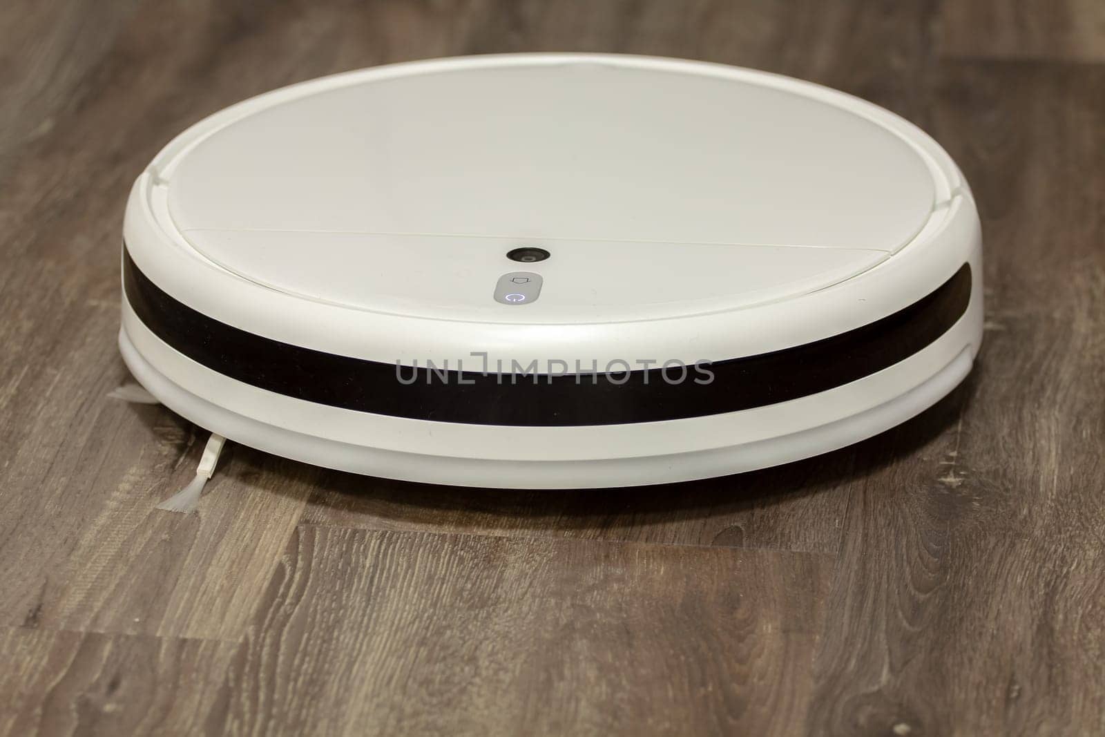 Modern digital home robot vacuum cleaner. Selective focus with shallow depth of field.