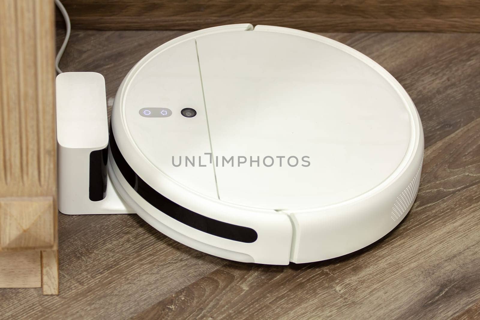 Modern digital home robot vacuum cleaner. Selective focus with shallow depth of field.