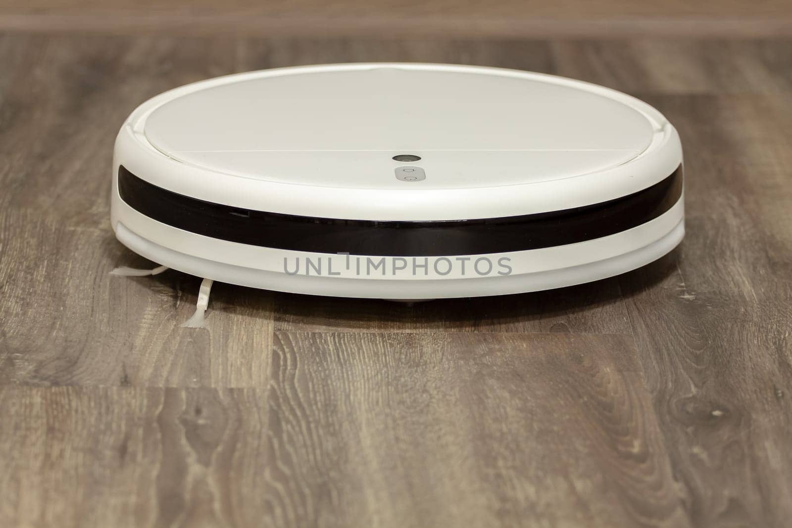 Modern digital home robot vacuum cleaner. Selective focus with shallow depth of field.