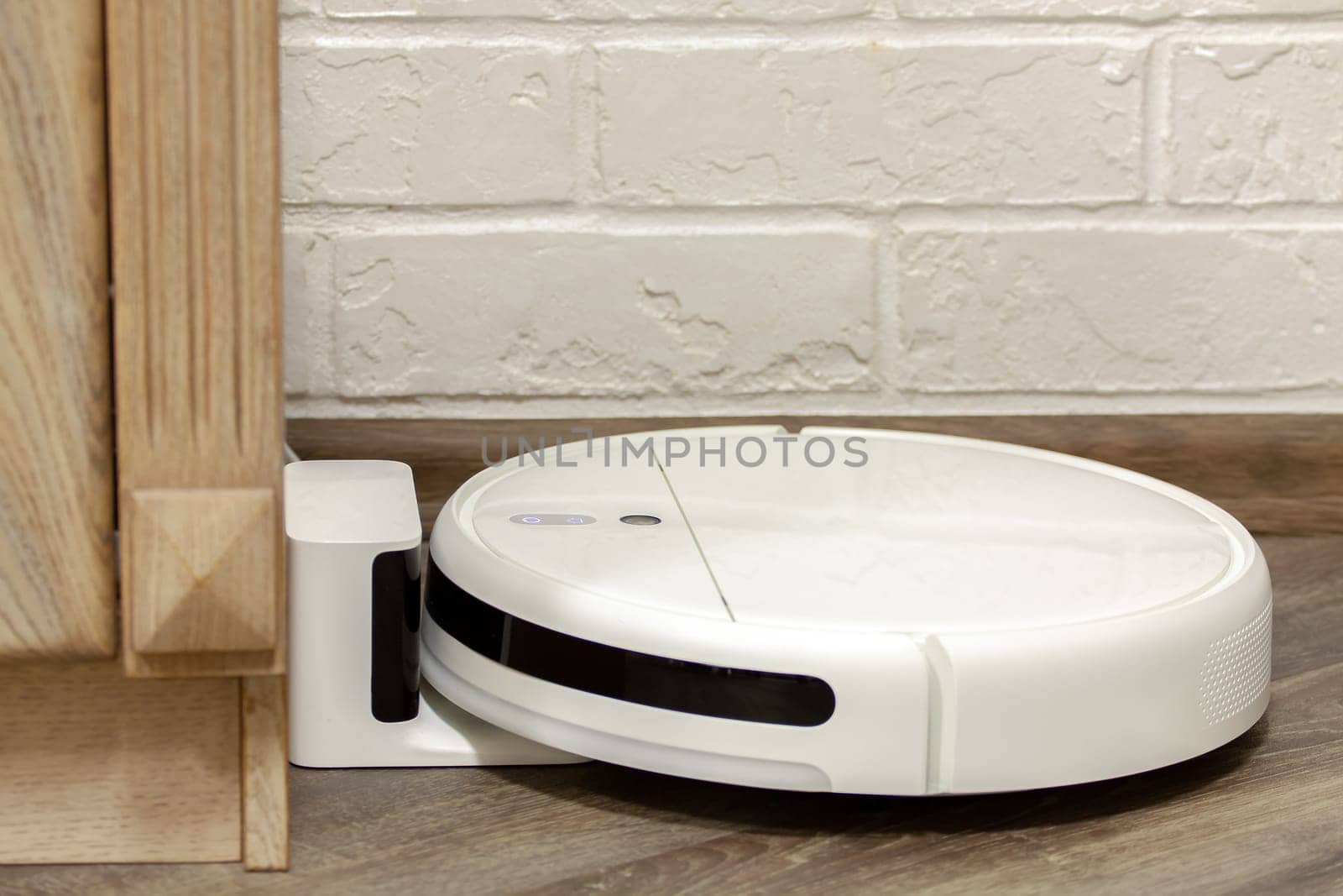 Modern digital home robot vacuum cleaner. Selective focus with shallow depth of field.