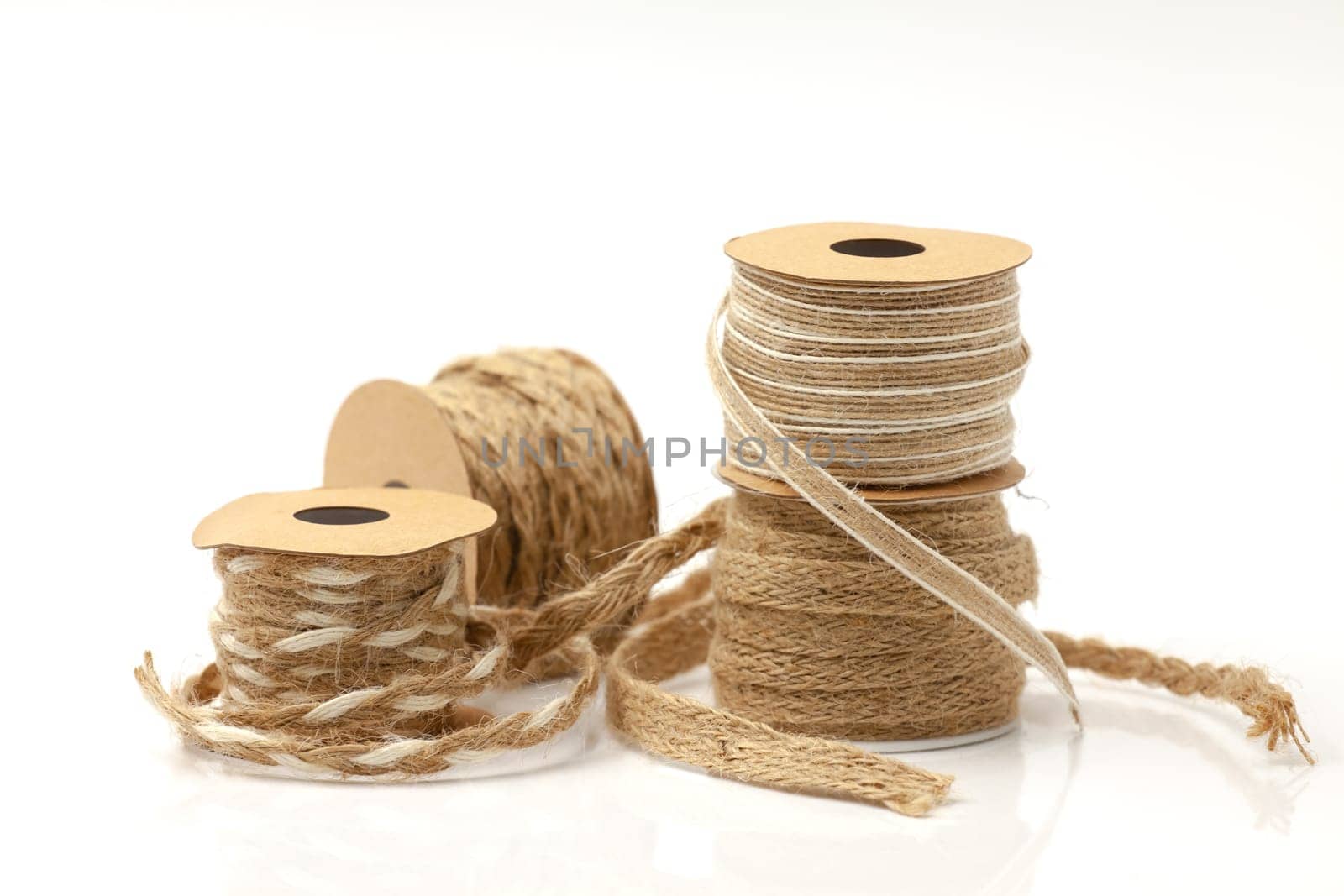 Rolls of braided cord of sackcloth and hemp for decoration and decoration. Selective focus with shallow depth of field.