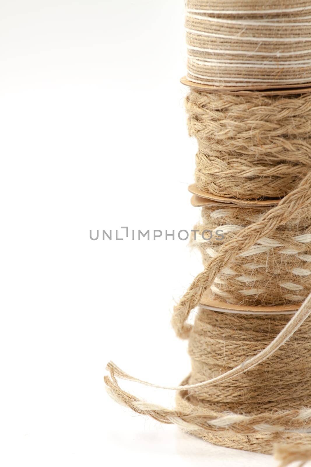 Rolls of braided cord of sackcloth and hemp for decoration and decoration. Selective focus with shallow depth of field.