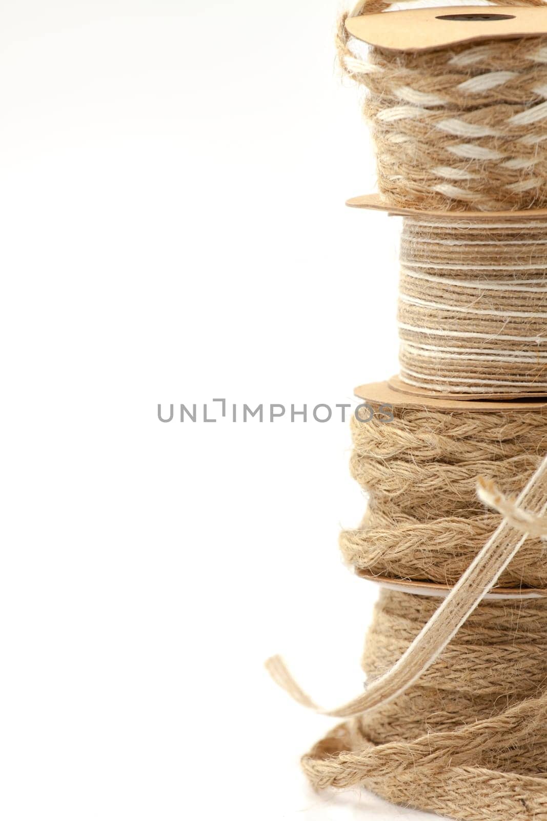 Rolls of braided cord of sackcloth and hemp for decoration and decoration. Selective focus with shallow depth of field.