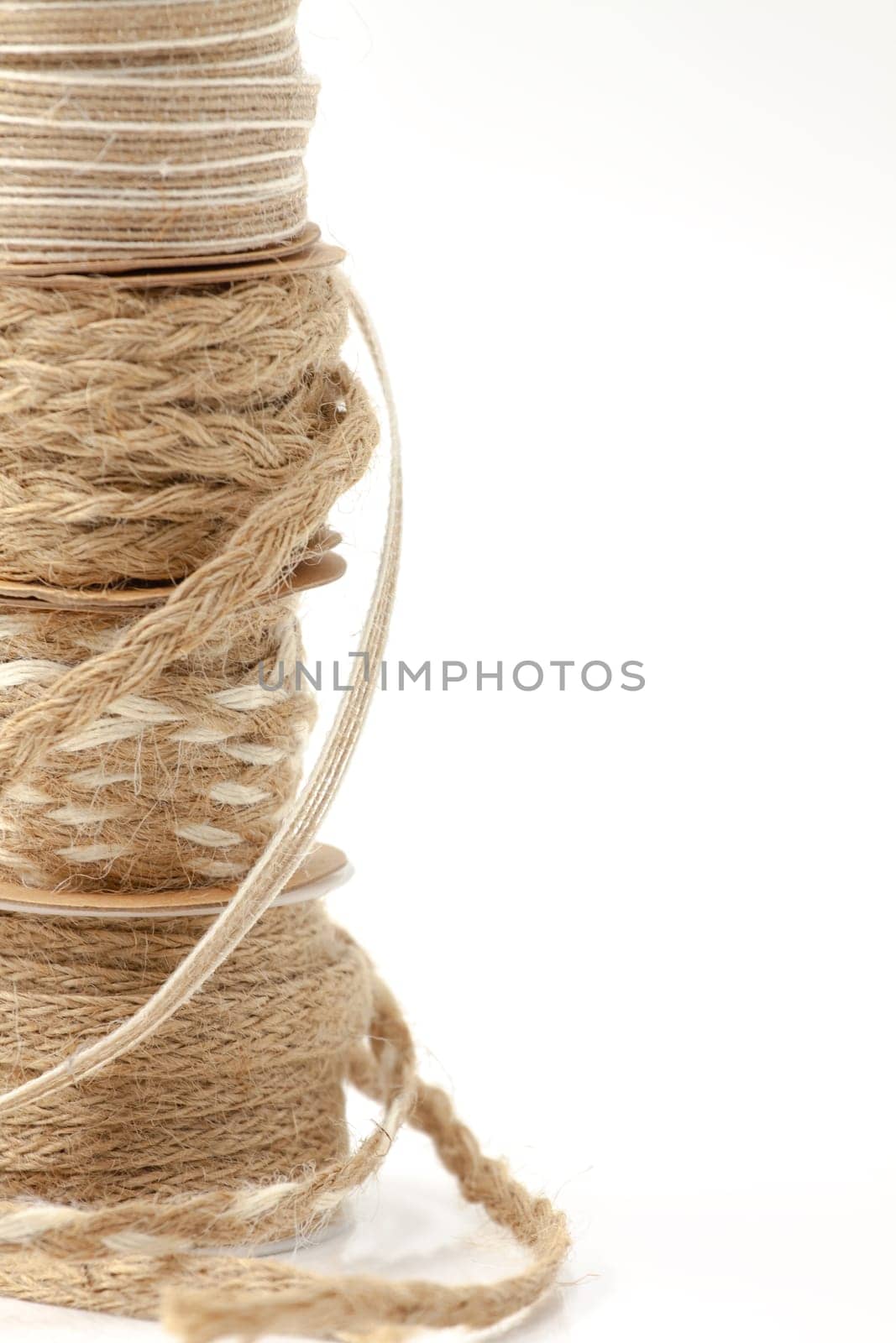 Rolls of braided cord of sackcloth and hemp for decoration and decoration. Selective focus with shallow depth of field.
