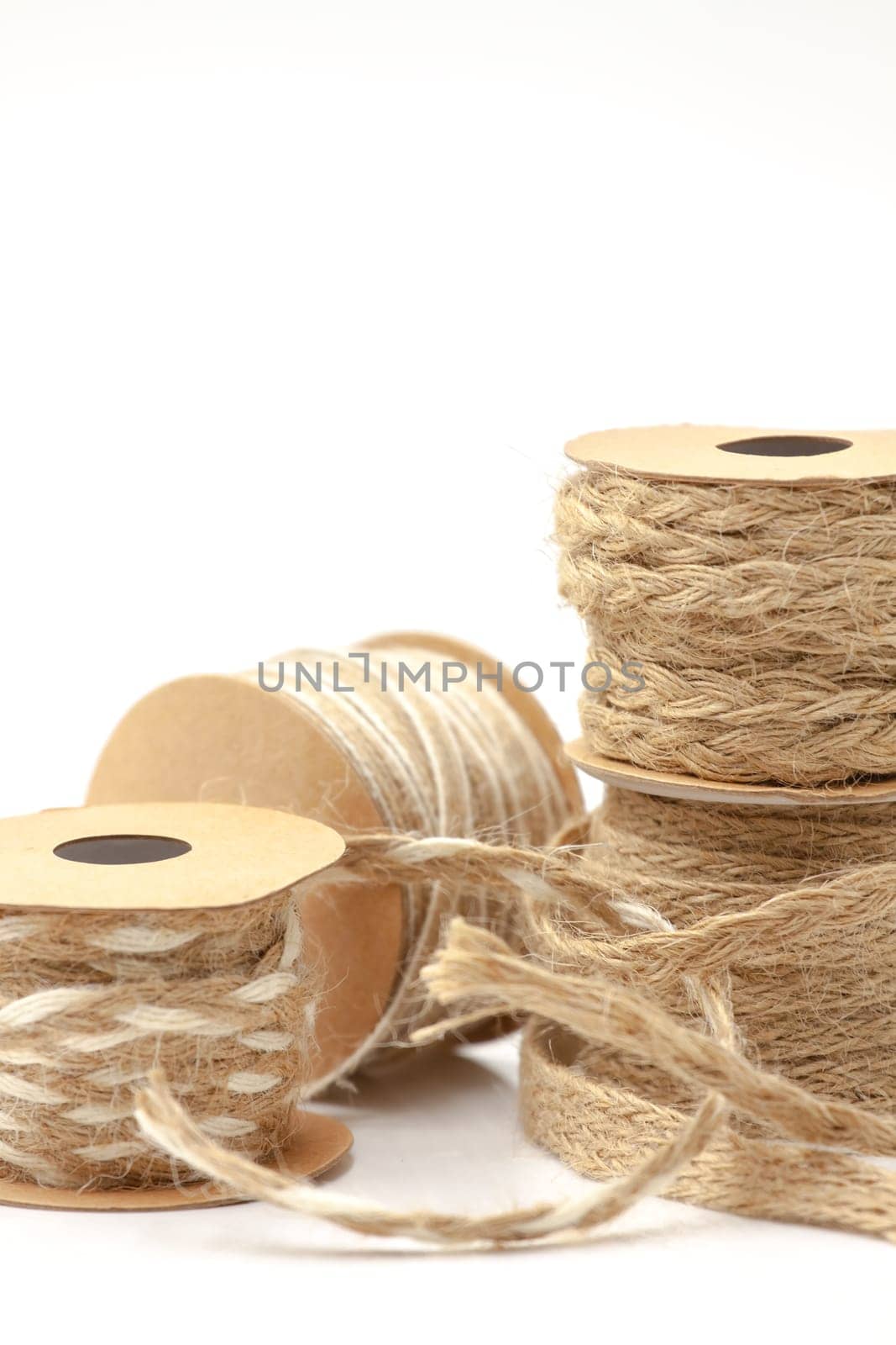 Rolls of braided cord of sackcloth and hemp for decoration and decoration. Selective focus with shallow depth of field.