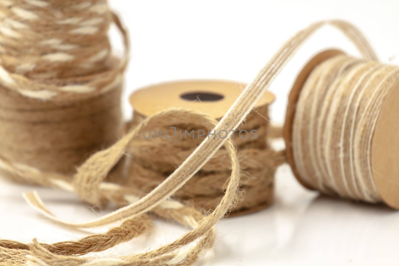 Rolls of braided cord of sackcloth and hemp for decoration and decoration. Selective focus with shallow depth of field.