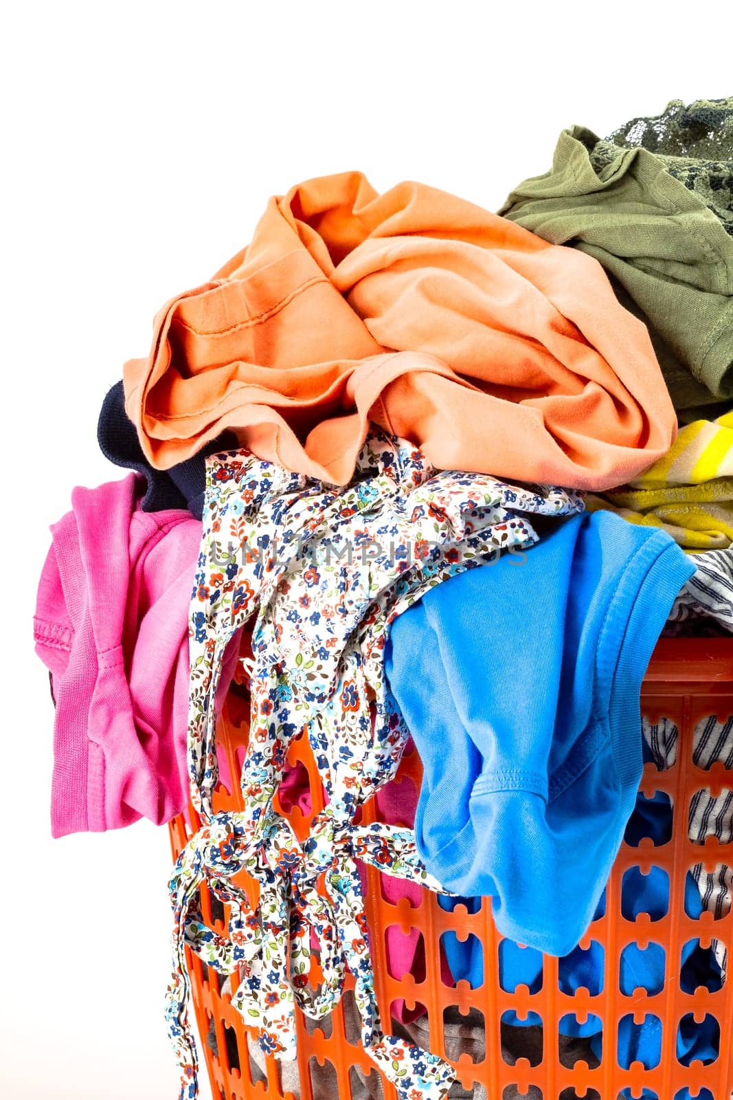 Red plastic laundry basket full of colorful clothes