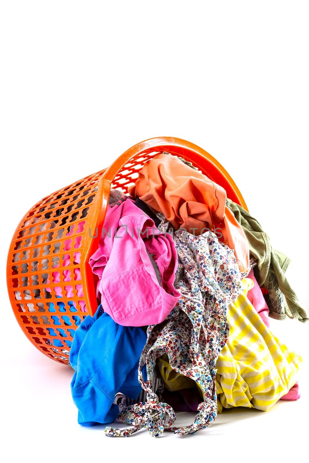Red plastic laundry basket full of colorful clothes