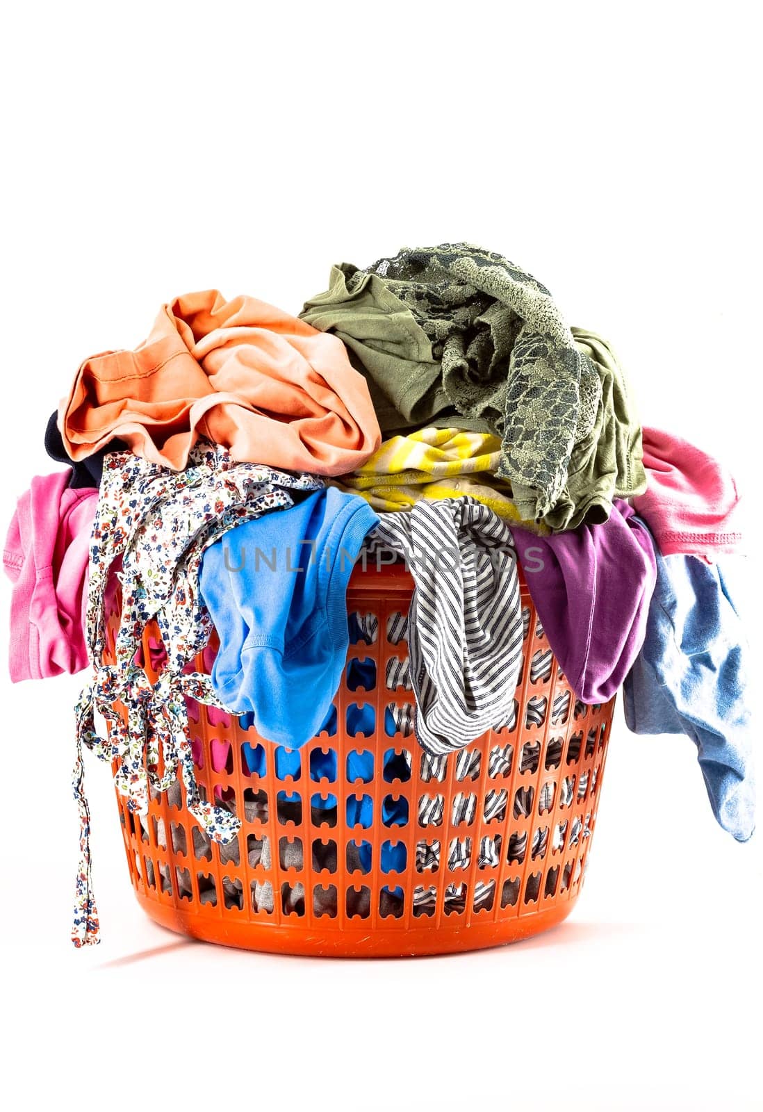 Red plastic laundry basket full of colorful clothes