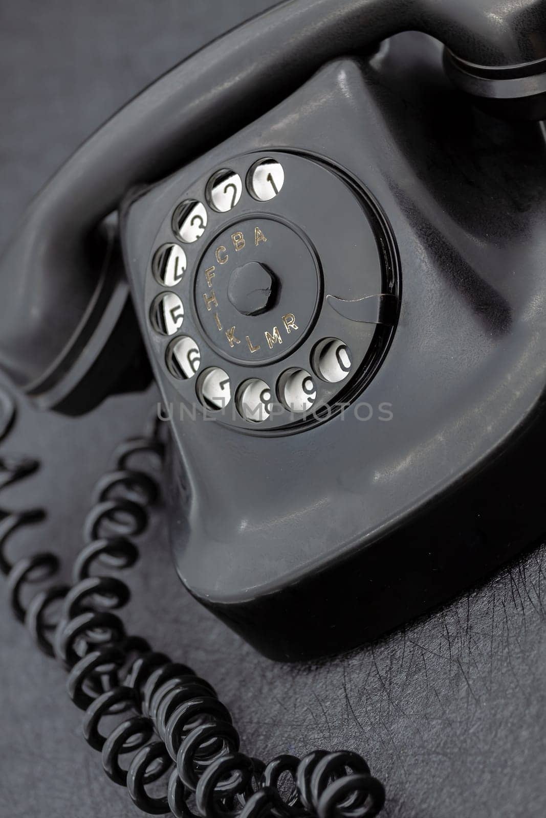 Vintage analog bakelite phone in black color. Selective focus with shallow depth of field.