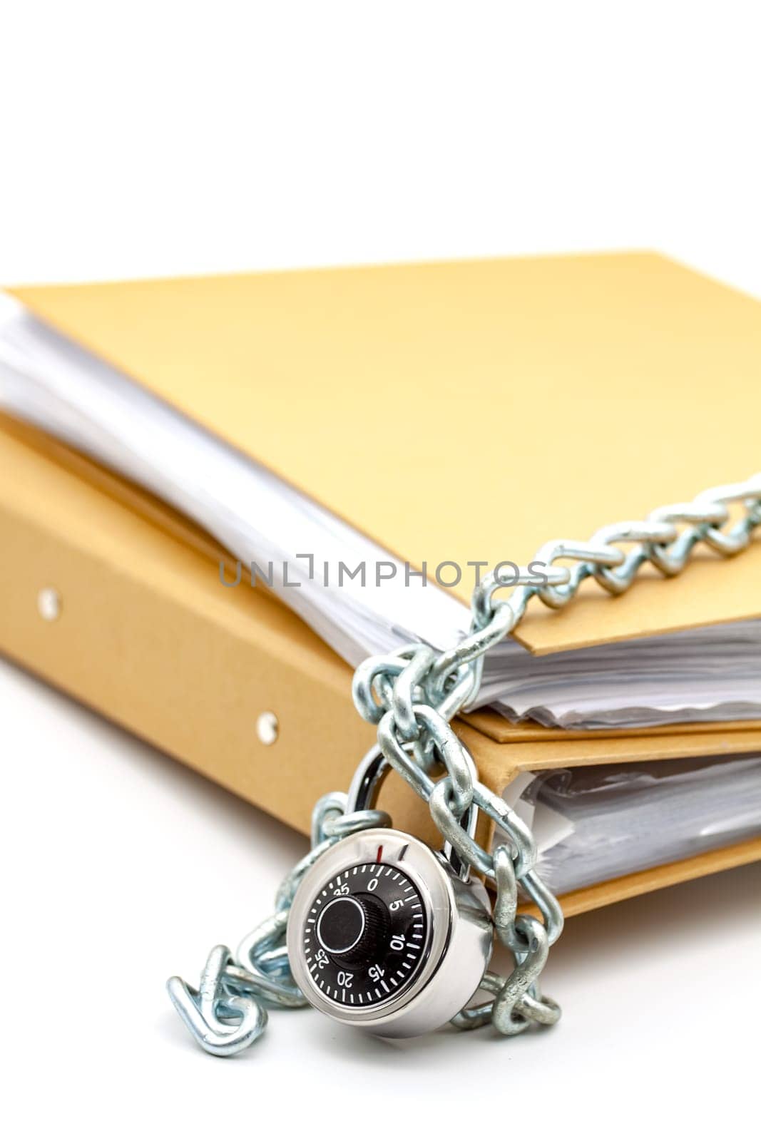 Cardboard document folders locked with chain and padlock. Selective focus with shallow depth of field.