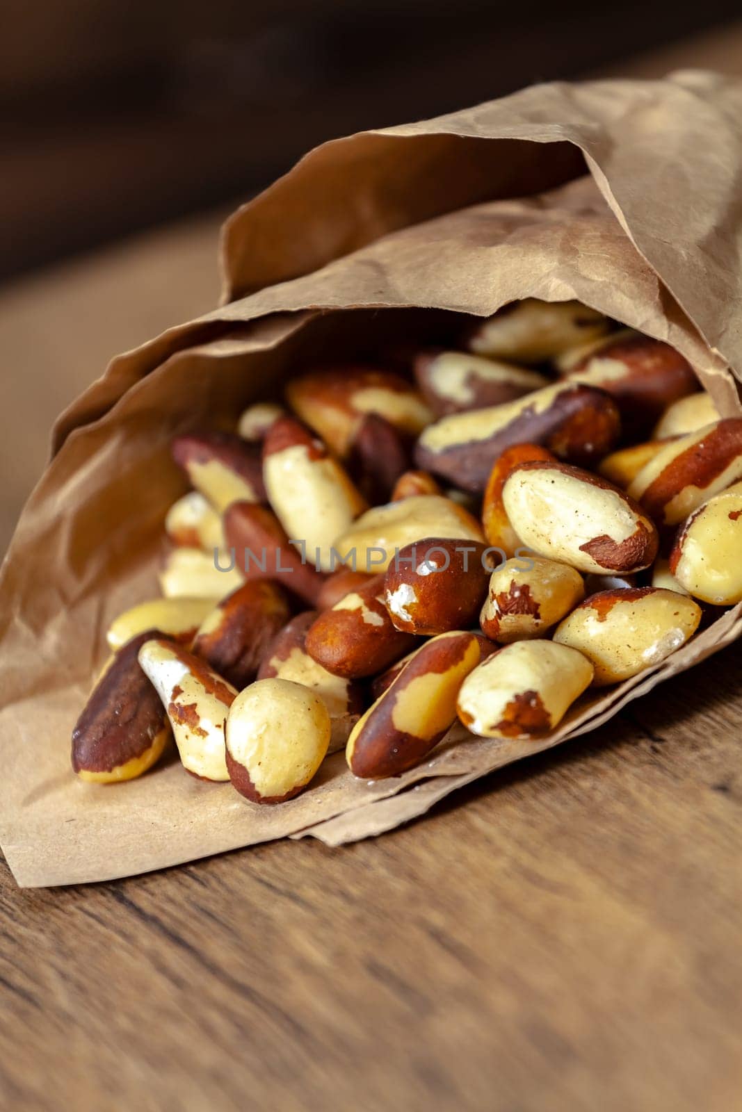Brazilian walnut in crumpled paper purse. Selective focus with shallow depth of field.