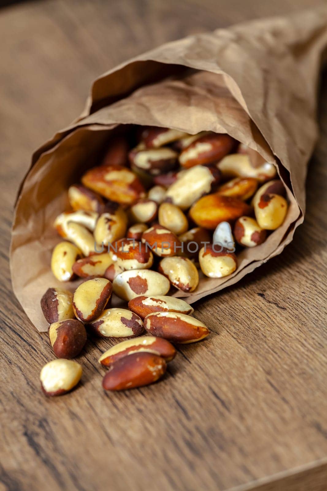 Brazilian walnut in crumpled paper purse. Selective focus with shallow depth of field.