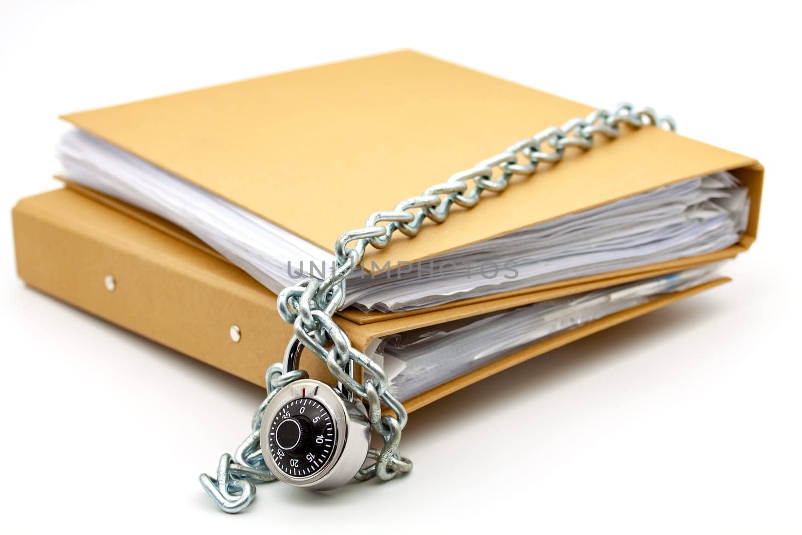 Cardboard document folders locked with chain and padlock. Selective focus with shallow depth of field.