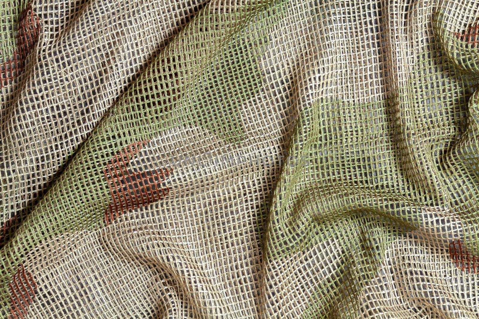 Close up of a military, tactical mesh camouflage scarf.