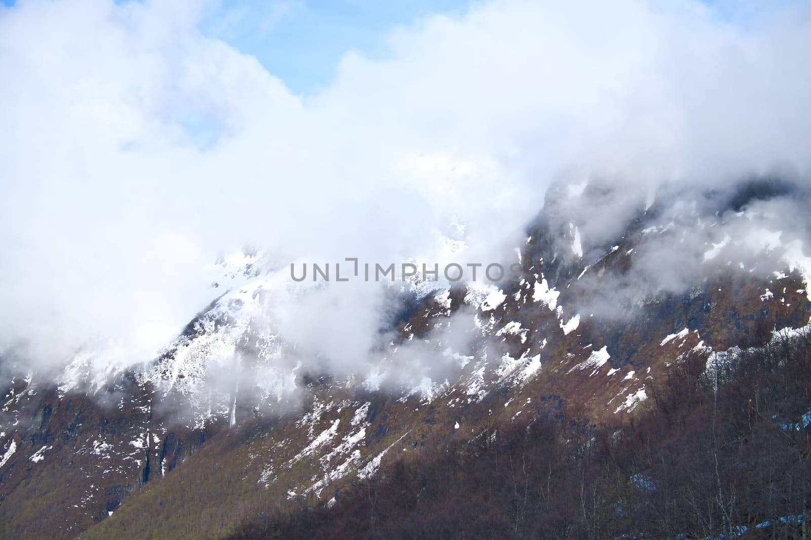 Norwegian landscape. The road leads through a mountain gorge that descends from the glacier. Rough nature in Scandinavia. Landscape photo from the north