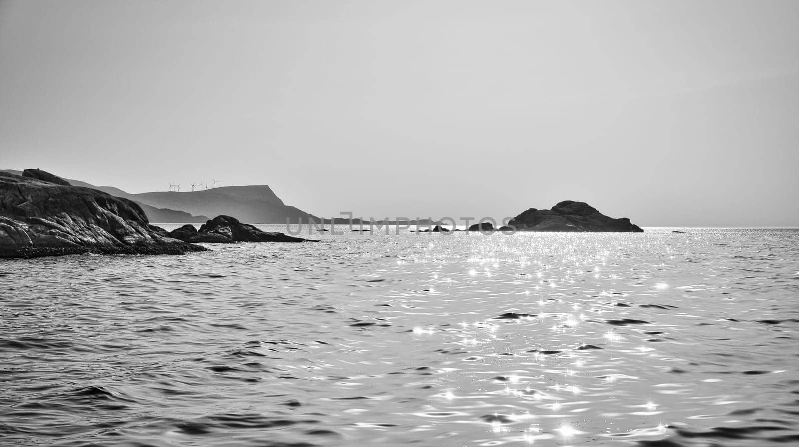 Norwegian fjord landscape. View of the open sea at the Western Cape in black and white. Crystal clear water, glistening in the sunshine. Landscape from Scandinavia