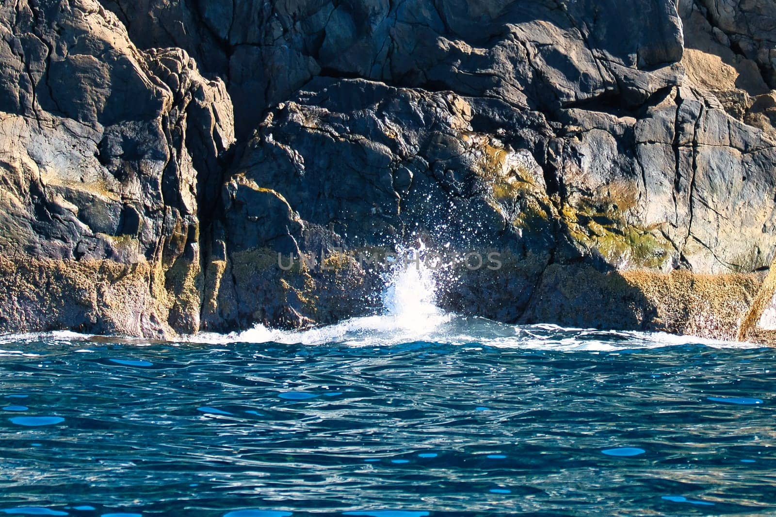 Norwegian fjord landscape. Waves crash against rocks. Water splashes against the rocks. Landscape in Scandinavia
