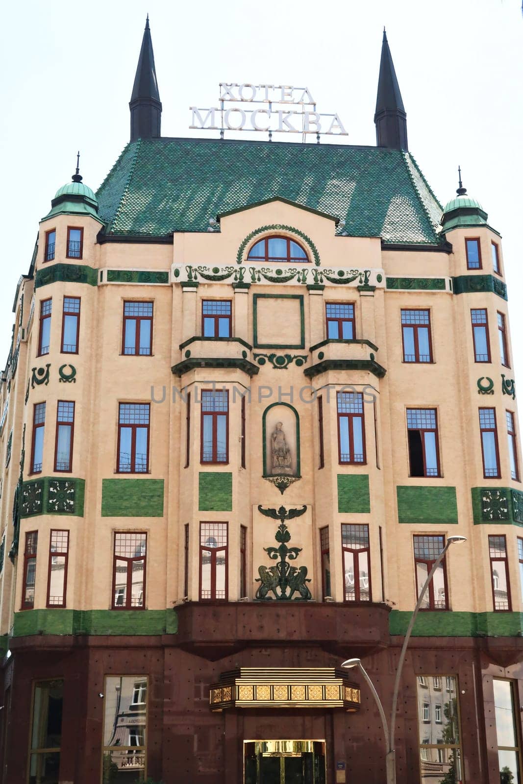 The front facade with many windows and green reliefs and the green roof of the Hotel Moskva, Palace Rossiya, an example of Art Nouveau architecture in the city center of Belgrade, Serbia 2022